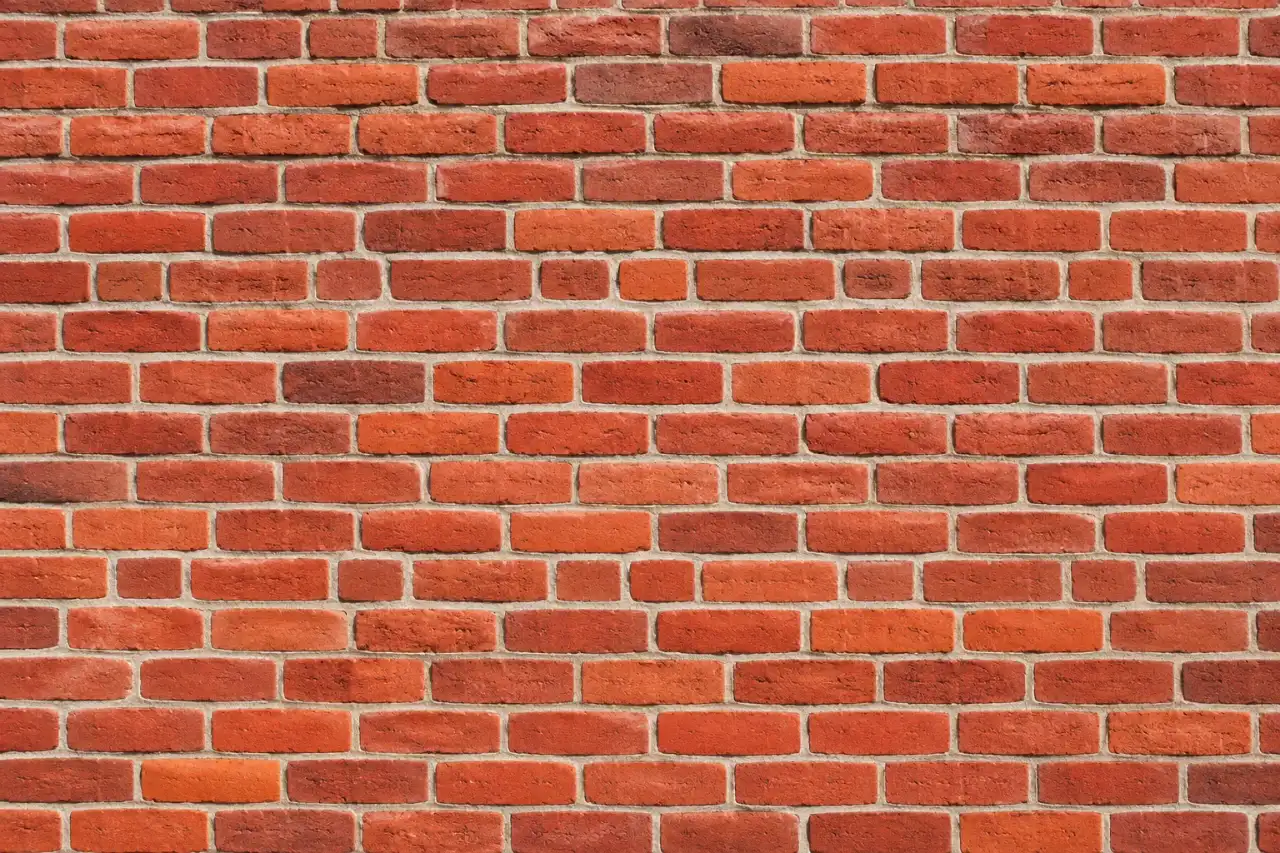 Close up of a red brick wall with light mortar joints